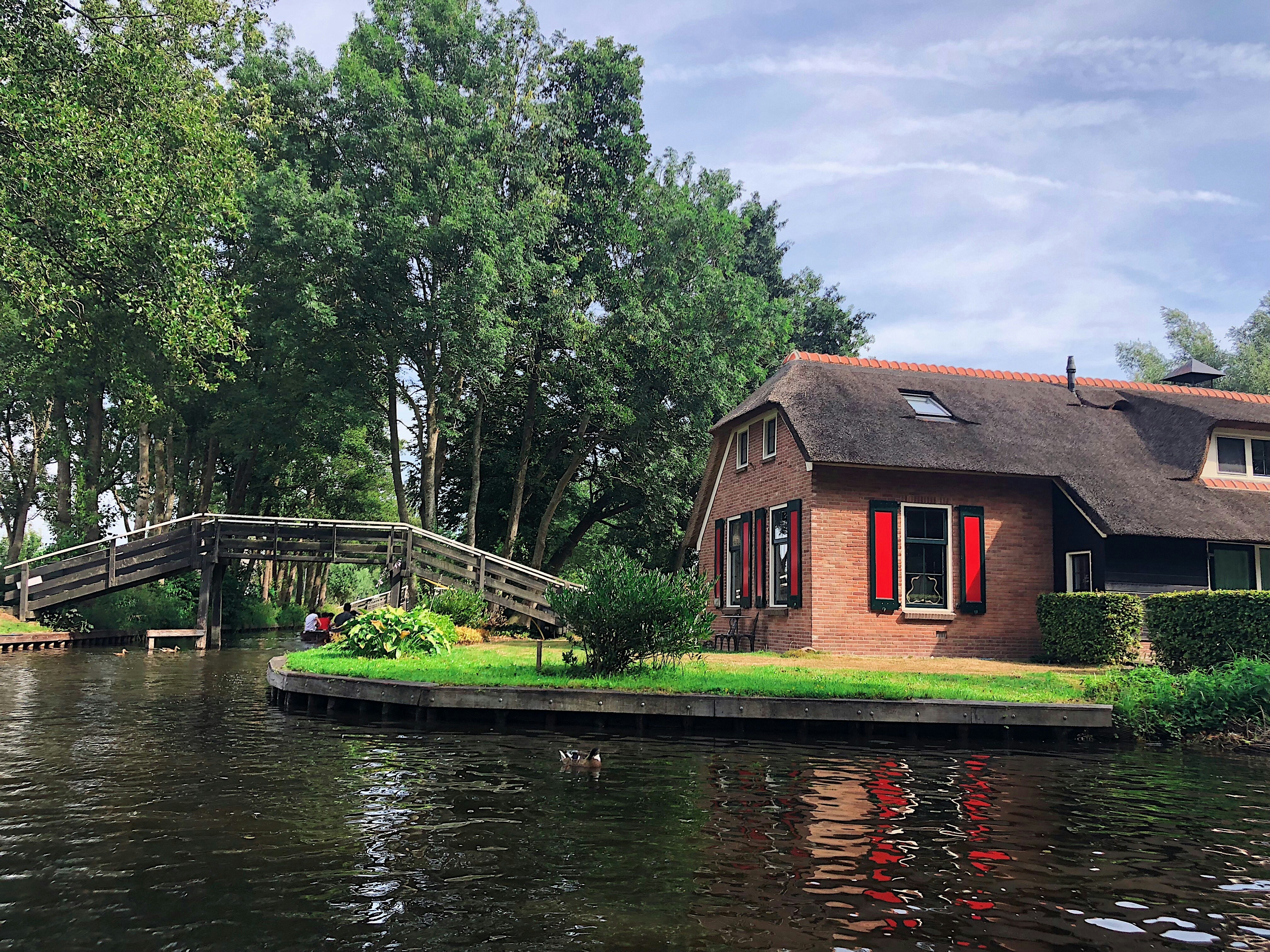 amsterdam canals and people riding bicycles
